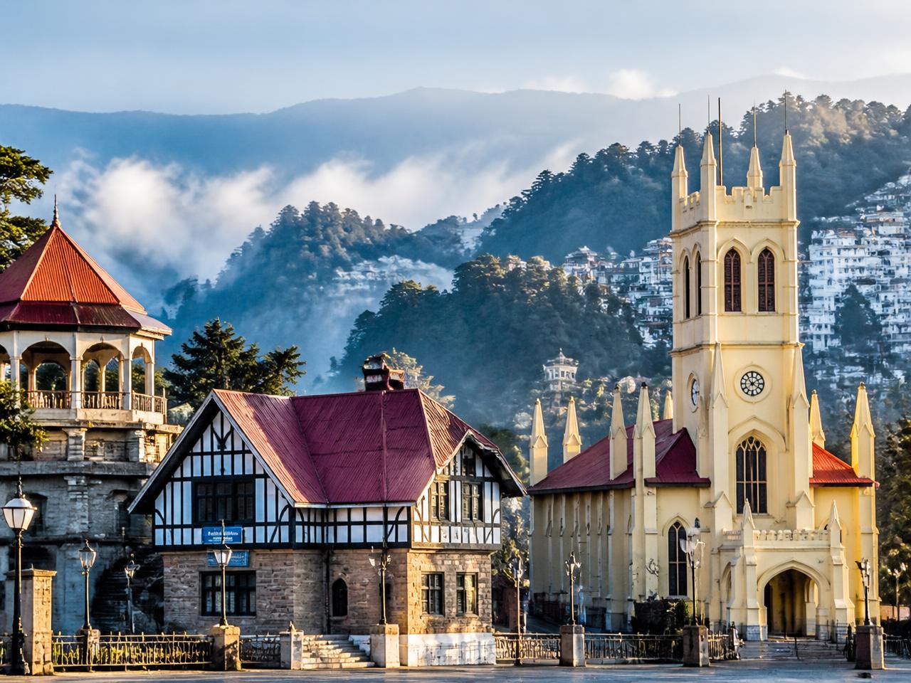 Misty pine hills and colonial buildings in Shimla